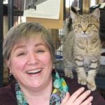 Author Ellen Rumsey with a rescue cat on her shoulder.