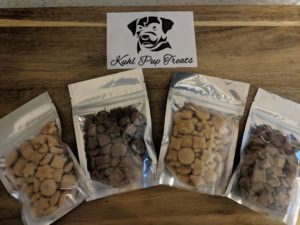 Image of Sample packs of the Khul Pup Treats. 4 small packages with different flavors.
